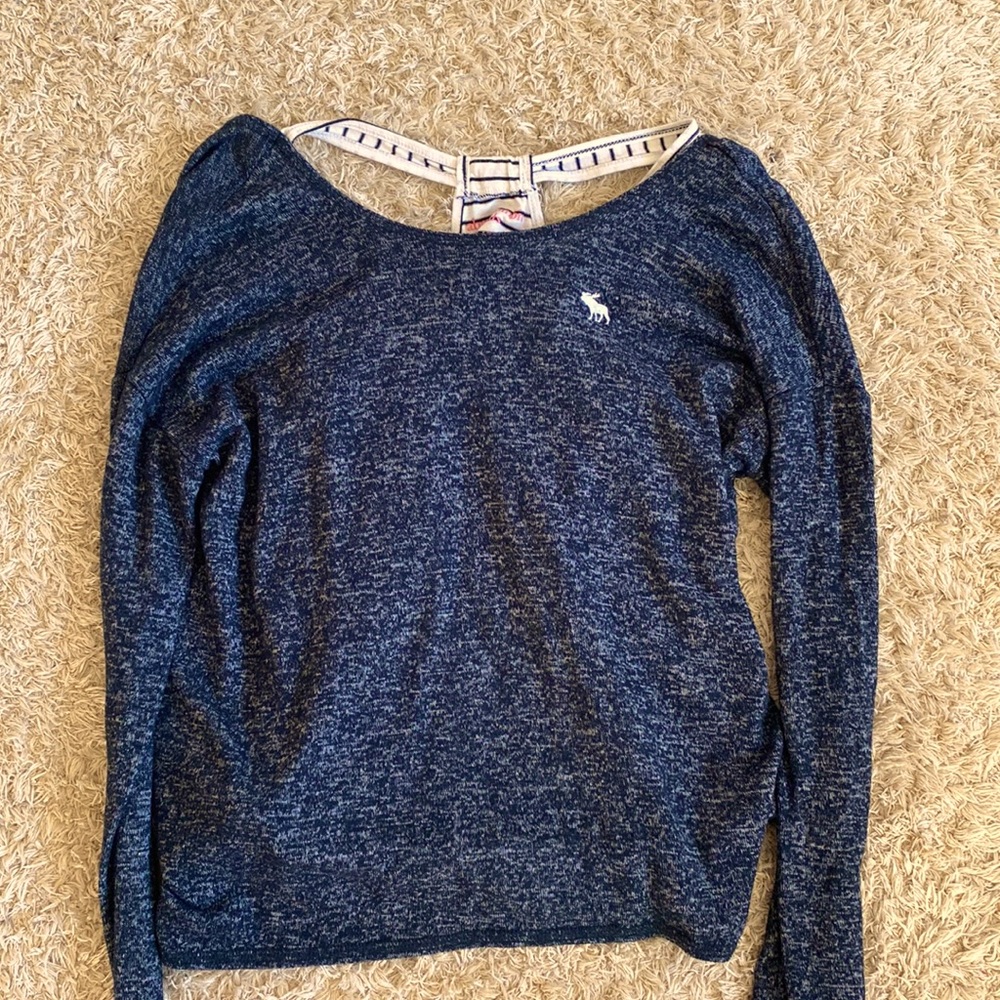 Blue long sleeve tee with inside shirt of black and white stripes.